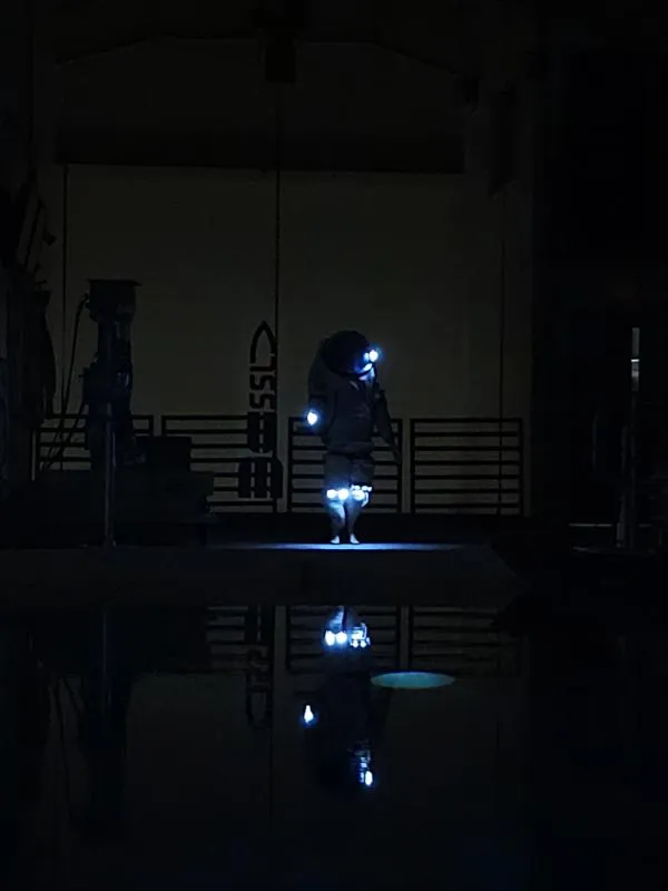 The lunar suit's integrated lighting system illuminated during an underwater test in the Neutral Buoyancy pool