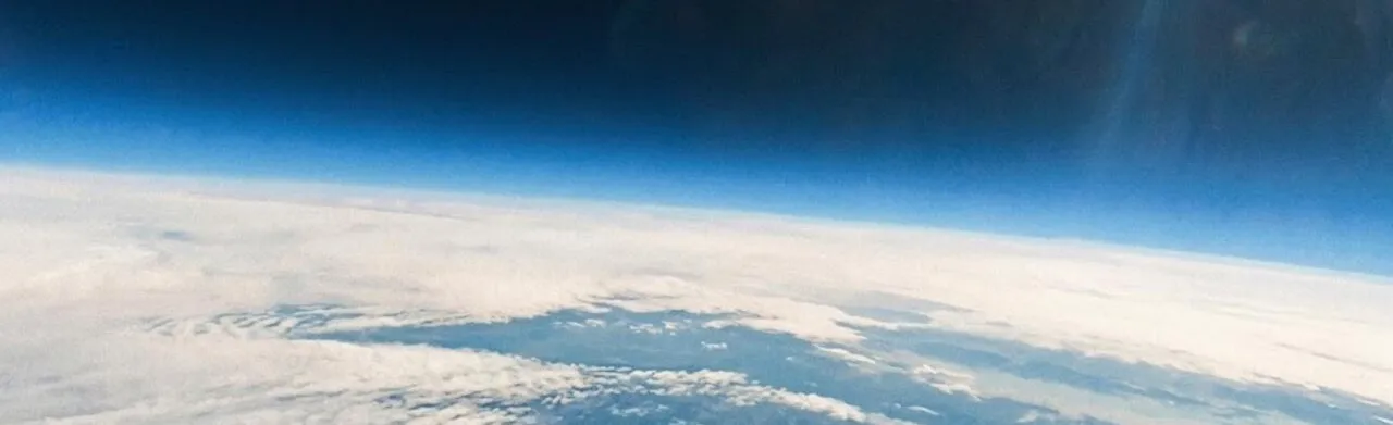 Earth's curved horizon and cloud layer, photographed from the payload during its high-altitude balloon flight
